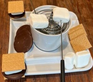 S'mores with chocolate, marshmallows, graham crackers, burner and marshmallow holder
