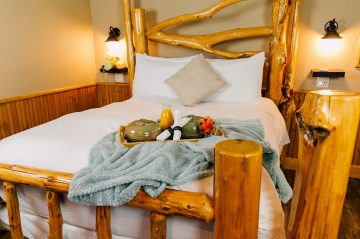 Ponderosa Suite bed with blanket on breakfast tray on top