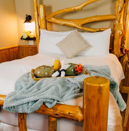 Ponderosa Suite bed with blanket on breakfast tray on top